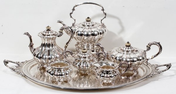 SILVER PLATE COFFEE SERVICE, SEVEN PIECES: SILVER PLATE COFFEE SERVICE, SEVEN PIECES:Including a water kettle with stand, coffee pot, teapot, covered sugar bowl, creamer and waste bowl. Accompanied by a silver plate tray L 32", D 19".