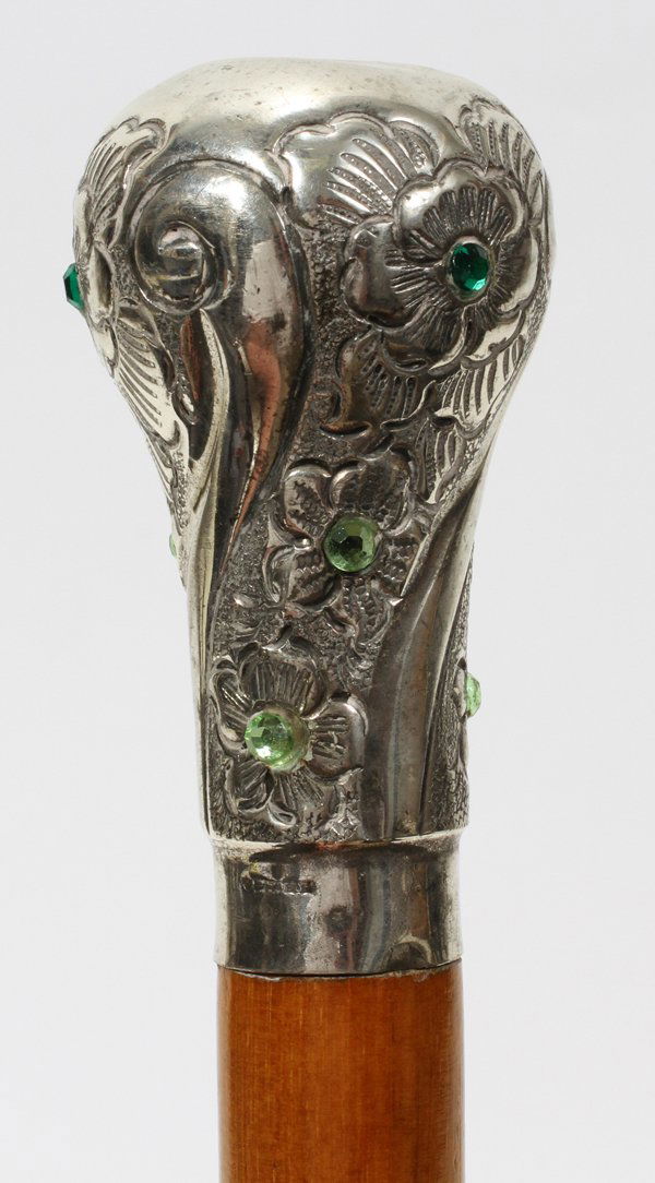 SILVER HANDLED SWORD CANE/WALKING STICK, EARLY: SILVER HANDLED SWORD CANE/WALKING STICK, EARLY 20TH C., L 38":A silver repousse handle set with faux gemstones, matching hallmarks at the base of the handle and the shaft fitting are unidentified and