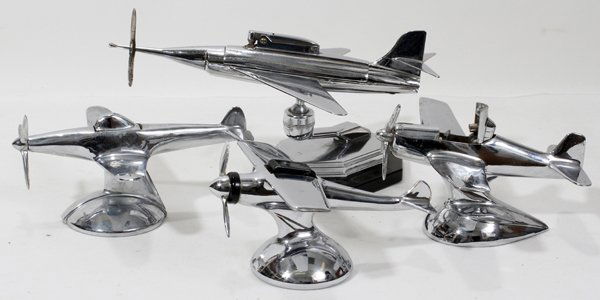 AMERICAN AIRPLANE-FORM TABLE LIGHTERS, FOUR, L: AMERICAN AIRPLANE-FORM TABLE LIGHTERS, FOUR, L 6"-9":Including 3 propeller airplanes marked "Flint Fuel/Made in the U.S.A., and 1 in the form of a fighter jet, no apparent markings.