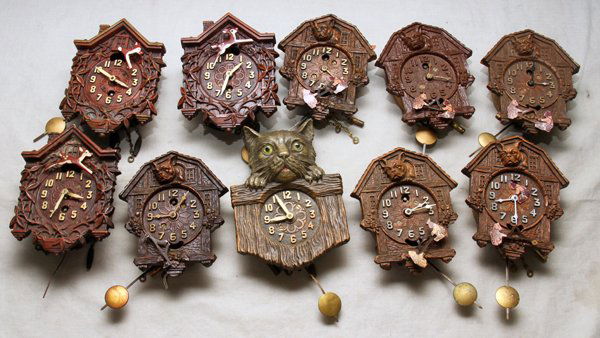 LUX/KEEBLER CLOCK CO. CHARACTER PENDULETTE CLOC: LUX/KEEBLER CLOCK CO. CHARACTER PENDULETTE CLOCKS (10), H 4 1/2"-5":Composition clocks with pendulums, including 3 Rudolph, 1 cat with glass eyes, and 6 bulldogs with lithographed paper kittens at the