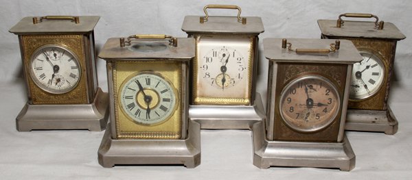 GERMAN METAL CARRIAGE CLOCKS, EARLY 20TH C., FI: GERMAN METAL CARRIAGE CLOCKS, EARLY 20TH C., FIVE, H 7" TO THE HANDLE:Including 2 Junghans, 1 Mauthe, 1 Kuehl, and 1 Meyerink.
