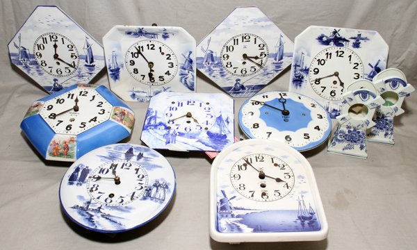 GERMAN WALL CLOCKS & CLOCK CASES, EARLY 20TH C.: GERMAN WALL CLOCKS & CLOCK CASES, EARLY 20TH C., ELEVEN, W 7 3/4"-8 3/4":Including 7 pottery or porcelain wall clocks, 2 enameled wall clocks, and 2 windmill-form clock cases, H.7"
