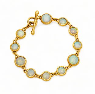 Tiffany & Co. Opal And 18K Yellow Gold Bracelet L 7": Tiffany & Co. Opal And 18K Yellow Gold Bracelet L 7" | Eleven round opals in 14K yellow gold conforming settings joined by a single chain link. the bracelet is joined by a yellow gold bar threaded