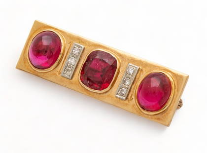 18kt Yellow Gold, Rubies & Diamond Pin, W 0.5" L 1.75" 10g: 18kt Yellow Gold, Rubies & Diamond Pin, W 0.5" L 1.75" 10g | Having central cushion cut ruby flanked by stacks of three melee diamonds and two cabochon rubies. Total weight: 10 grams. Provenance: Prop