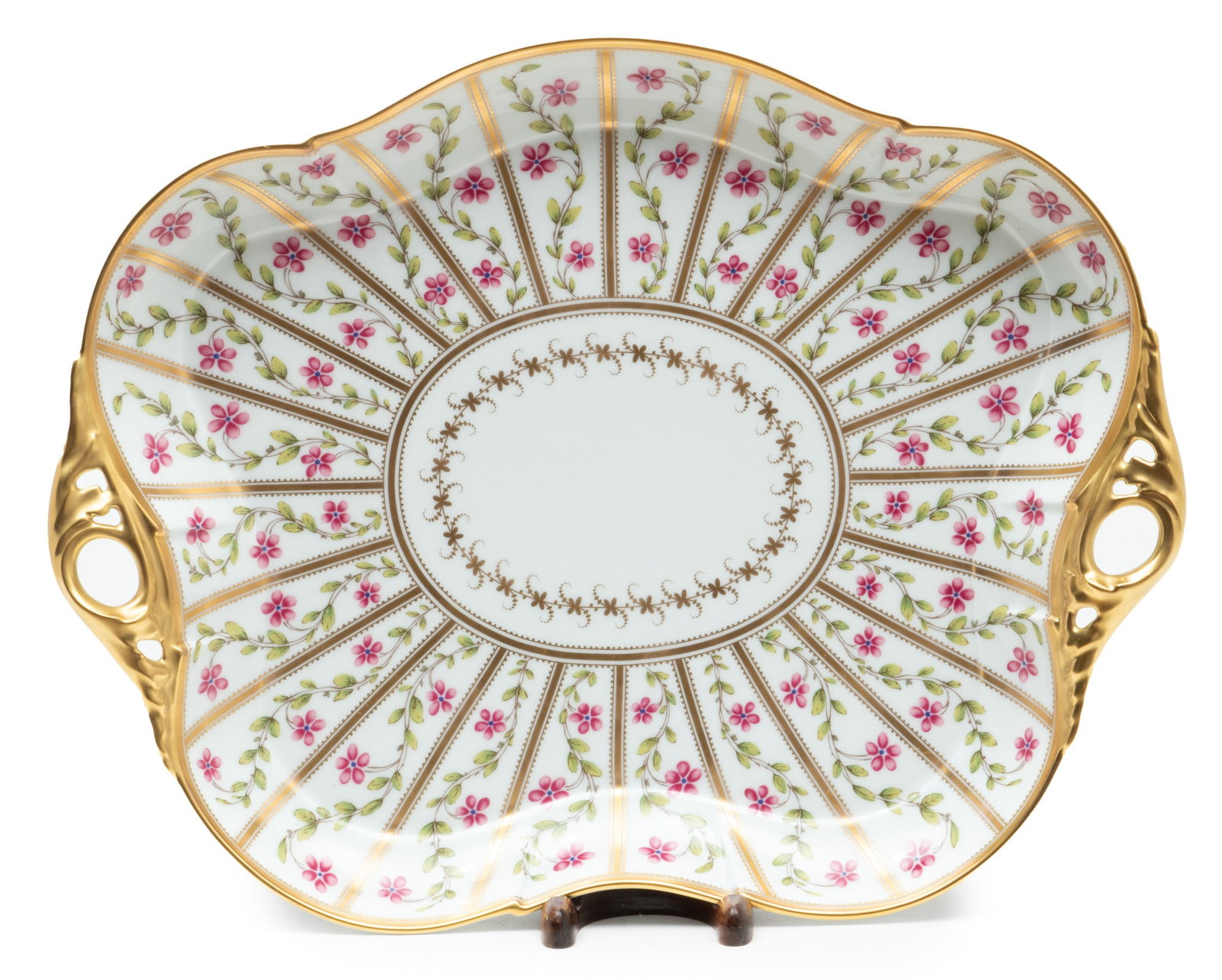 Limoges (French) Porcelain Tray, W 4" L 11": Limoges (French) Porcelain Tray, W 4" L 11" | Having two handles, gold border, and scrolling floral hand painted design. Marked "Ancienne Manufacture Royale".