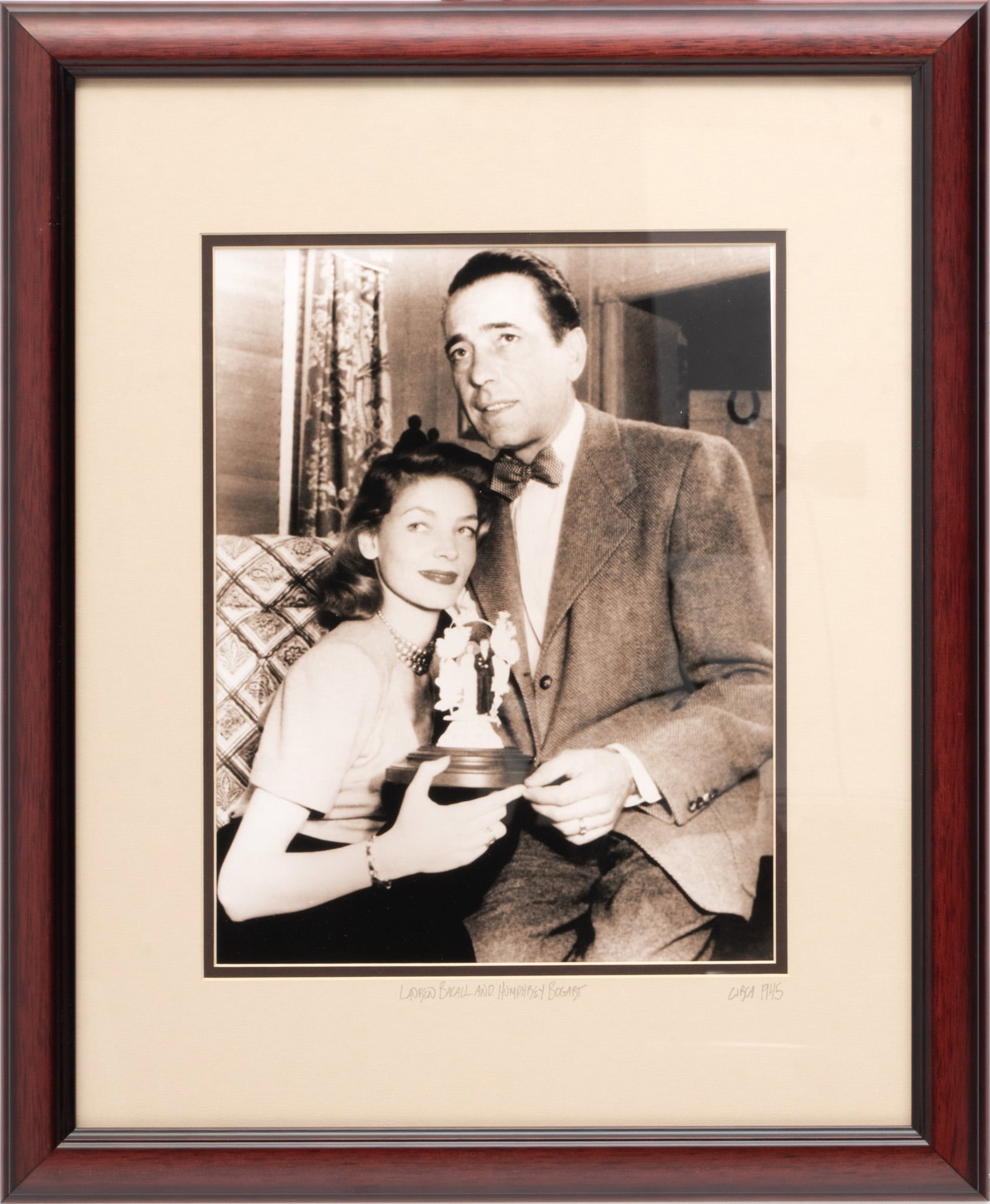 Lauren Bacall And Humphrey Bogart Photograph, Ca. 1945, H 13.25" W 10.25": Lauren Bacall And Humphrey Bogart Photograph, Ca. 1945, H 13.25" W 10.25" | Mark Reuben Gallery Certificate verso. Framed H 23", W 18.5". Provenance: The Bethany Belanger collection, Port Huron, MI. P