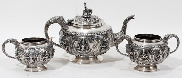 INDIAN SILVER TEA SET, THREE PIECES, H 3"- 5": INDIAN SILVER TEA SET, THREE PIECES, H 3"- 5":Including 1 teapot, 1 sugar bowl (lacking cover) and 1 creamer. Teapot measures 5 3/8" in height. All are decorated with Krishna in various poses and elep