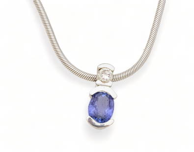 Tanzanite And Diamond Pendant on 14K White Gold Chain: Tanzanite And Diamond Pendant on 14K White Gold Chain | Oval tanzanite approx. 1.42 carat. Full cut diamond approx.0 .20 ct. (SI and GH color) Chain impressed 585 and Italy. 14 K white gold 18" chain.