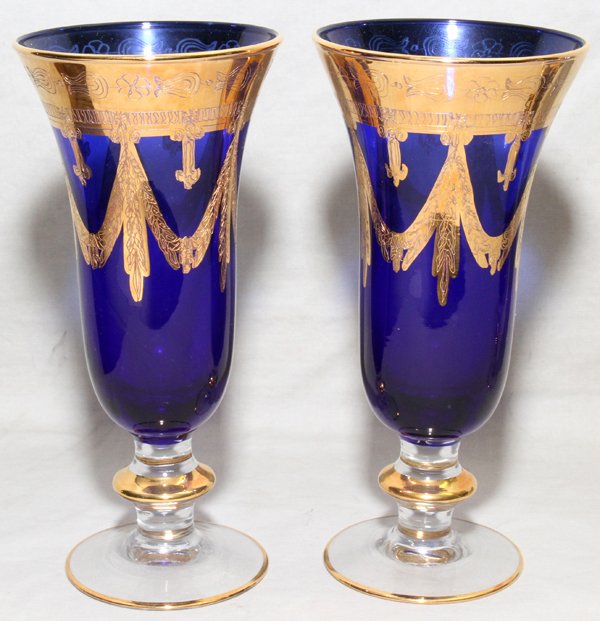 GOLD COBALT TO CLEAR GLASS CHAMPAGNE FLUTES: FIRED GOLD COBALT TO CLEAR GLASS CHAMPAGNE FLUTES, TWENTY, H 7 1/2":Each with a cobalt body and clear stem with fired gold accents.