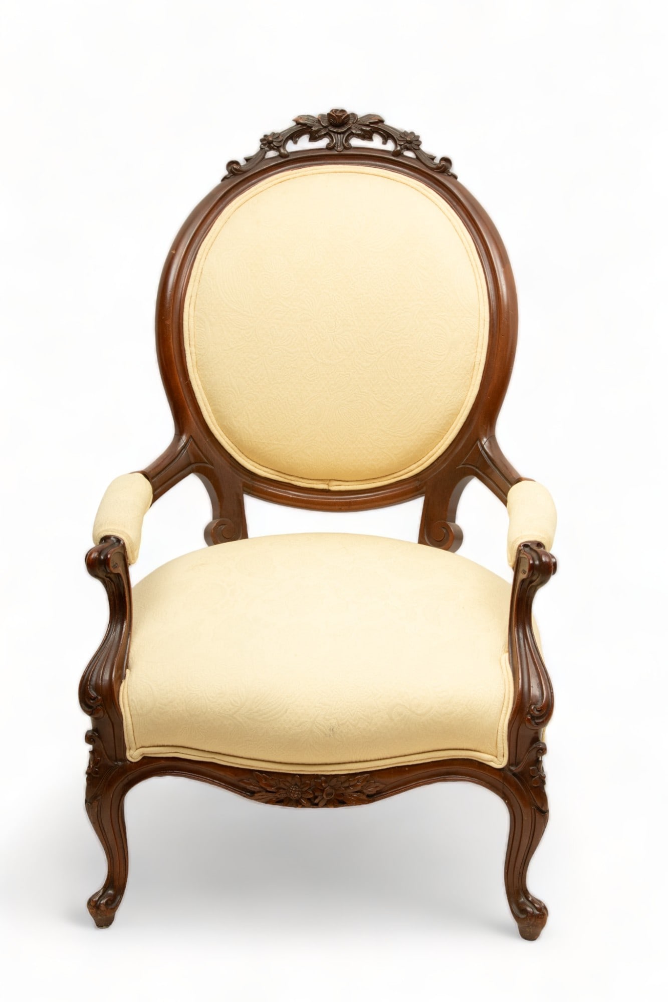 Victorian Carved Mahogany Open Arm Chair, Ca. 1890, H 39" W 25" Depth 22": Victorian Carved Mahogany Open Arm Chair, Ca. 1890, H 39" W 25" Depth 22" | Carved rose and daisies at crest. French curved legs. Having a spring seat and upholstered back in yellow fabric. Circa 1890