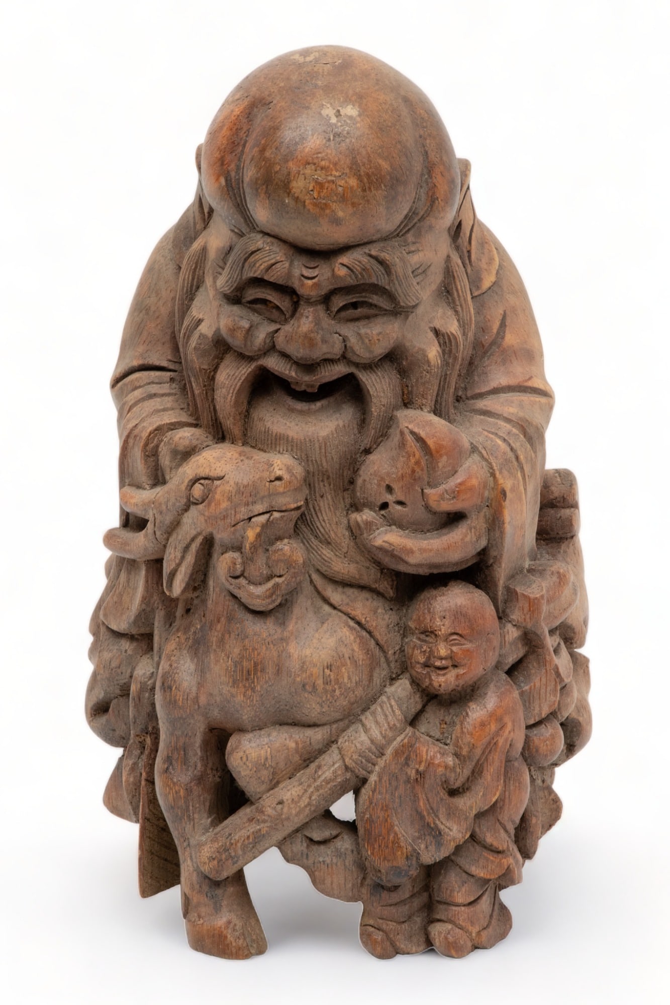 Chinese Carved Bamboo Figure of Shoulao, Ca. 1900, H 10.75" Dia. 6": Chinese Carved Bamboo Figure of Shoulao, Ca. 1900, H 10.75" Dia. 6" | This carved bamboo figure represents Shoulao, the Chinese god of longevity and prosperous life. He is portrayed in a moment of mot