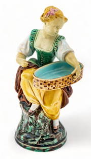 Minton (English) Majolica Ceramic Figurine, Young Maiden with Basket, Ca. 1900, H 7.5" W 4" Depth: Minton (English) Majolica Ceramic Figurine, Young Maiden with Basket, Ca. 1900, H 7.5" W 4" Depth 3.75" | Depicting a young maiden with a woven basket. Boasting rich emerald, turquoise, and ochre tone