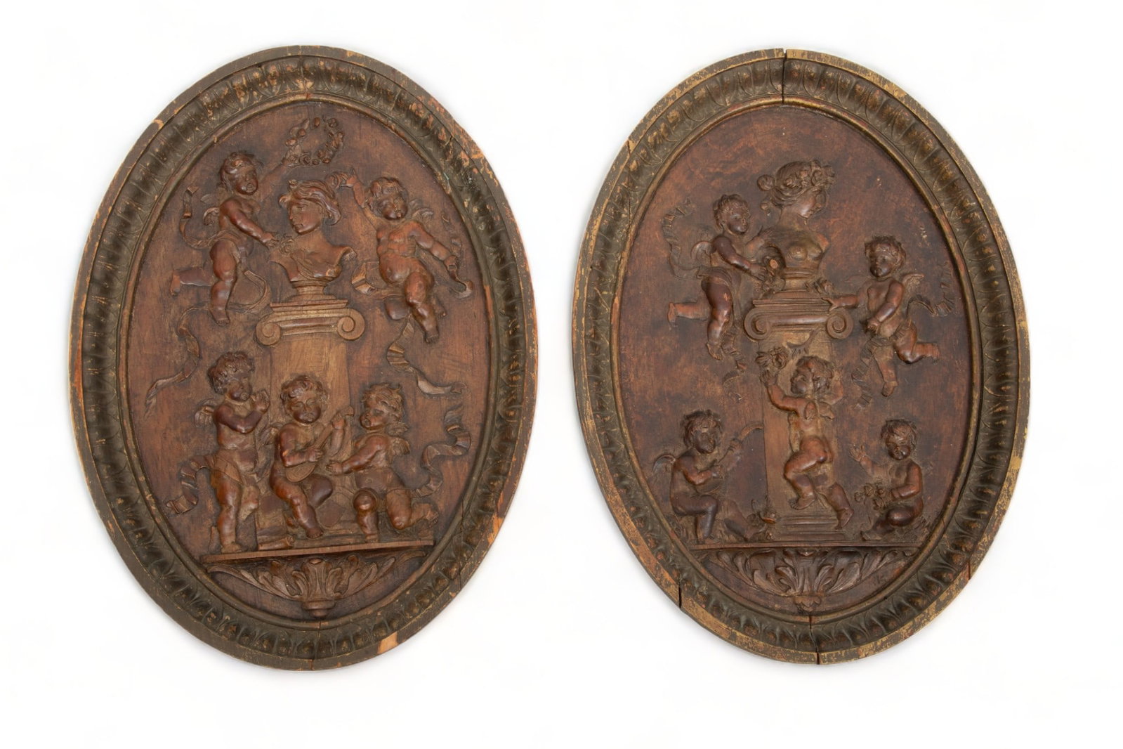 English/Scottish Bas Relief Carved Oval Plaques 19th C., H 17.75" W 12.25" 1 Pair: English/Scottish Bas Relief Carved Oval Plaques 19th C., H 17.75" W 12.25" 1 Pair | Each depicting putti dancing around garden sculpture whilst one plays the mandolin. Plaques are early 19th century a