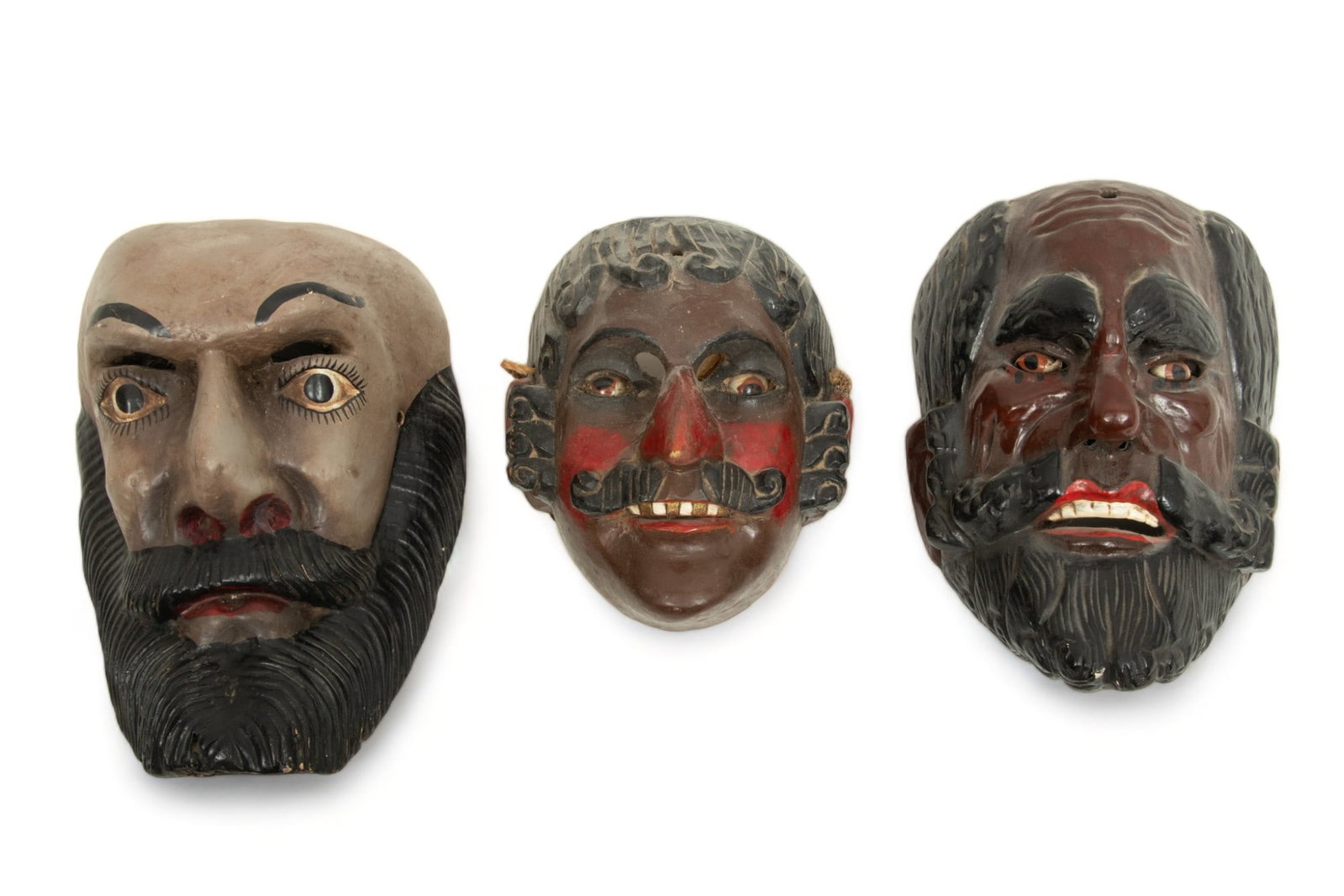 Guatemalan Polychrome Carved Wood Conquistador Masks, 20th C., 3 pcs: Guatemalan Polychrome Carved Wood Conquistador Masks, 20th C., 3 pcs | Lot includes one mask of a conquistador with a full beard, painted metal inset eyes. H 10", W 7.25", D. 5.25". One mustachioed co