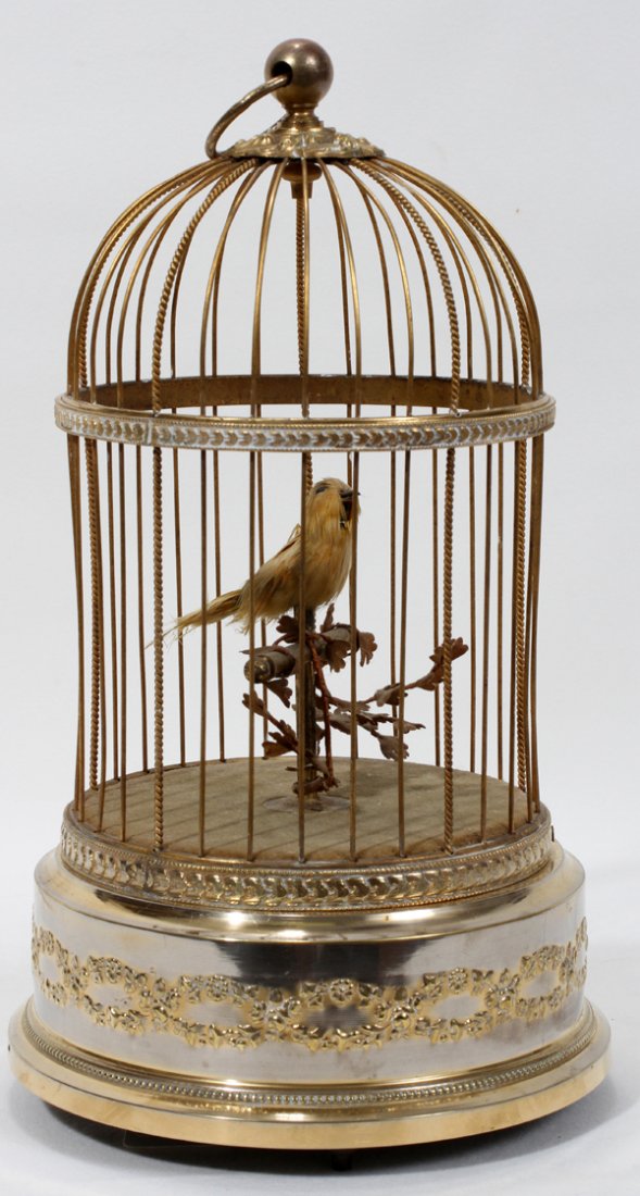 FRENCH SINGING BIRD IN CAGE, MUSIC BOX, H 11": FRENCH SINGING BIRD IN CAGE, MUSIC BOX, H 11", DIA 6 1/2":Brass cage with yellow mechanical bird. Vintage, circa 1910.