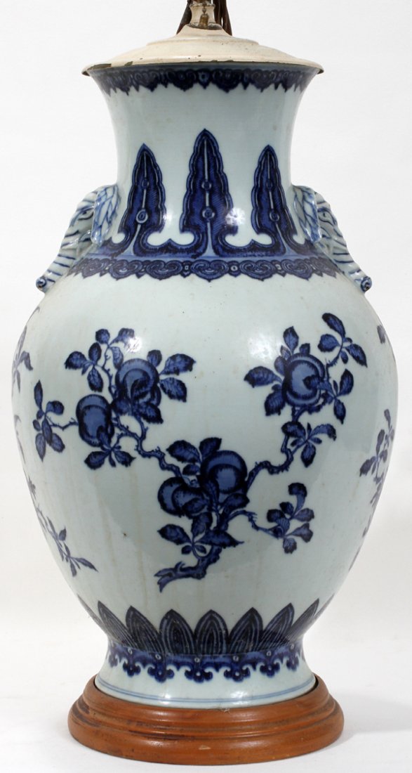 ORIENTAL PORCELAIN URN LAMP, H 31", D 11": ORIENTAL PORCELAIN URN LAMP, H 31", D 11":Porcelain urn converted to lamp. Hand painted with light blue base & navy flower and leaf design. Spear head designs & scrolling throughout. Elephants flank t