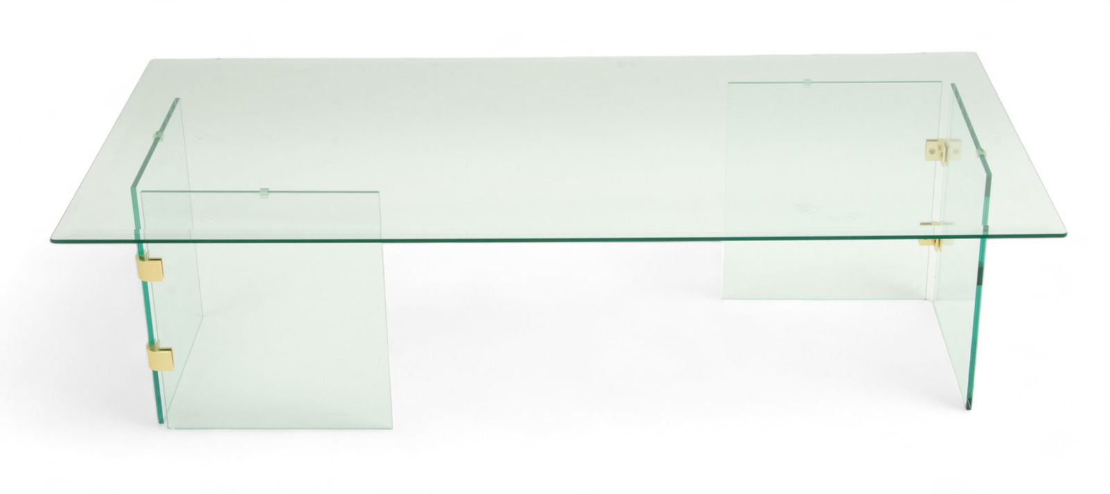 Leon Rosen (American) for Pace Collection, Glass Top Coffee Table Ca. 1970, H 15.25" W 25.75" L 51.7: Leon Rosen (American) for Pace Collection, Glass Top Coffee Table Ca. 1970, H 15.25" W 25.75" L 51.75" | Glass panel base, joined with brass fastenings and a thick glass top. Provenance: Property from
