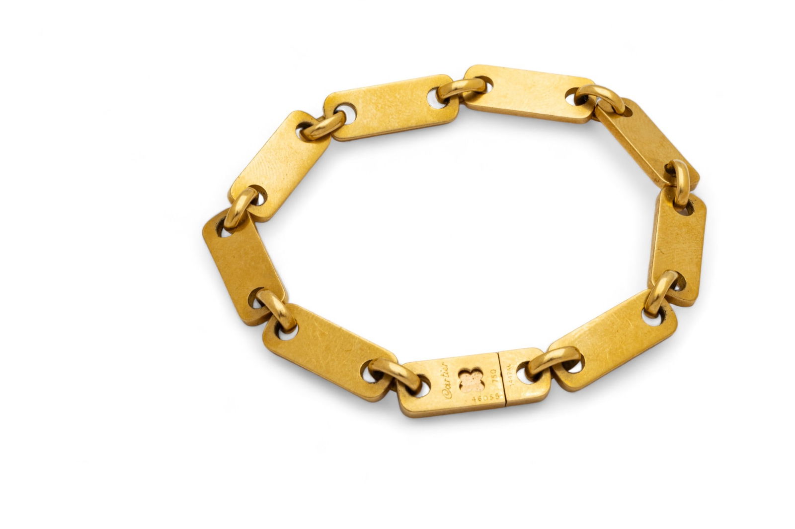 Cartier (French) 750 Yellow Gold Bracelet, W 0.25" L 7.5" 31g: Cartier (French) 750 Yellow Gold Bracelet, W 0.25" L 7.5" 31g | with eight links and clasp, which bears signature branding, '46055' and '1447AL', and hallmarks. Total weight: 31 grams. Provenance: Pro