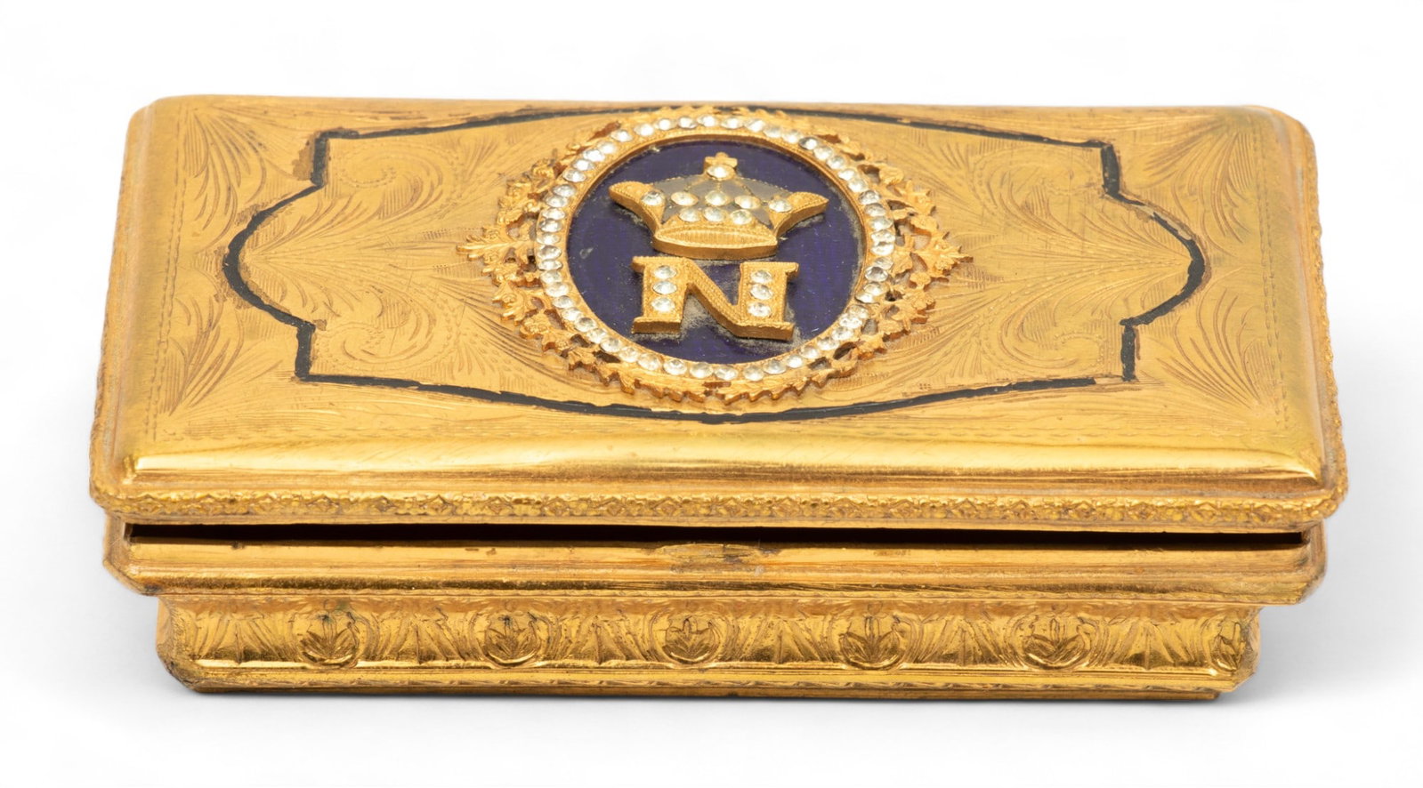 Italian GIlt Metal Box, Napoleonic Crest Ca. 1960, L 3.7" Depth 2": Italian GIlt Metal Box, Napoleonic Crest Ca. 1960, L 3.7" Depth 2" | Hinged cover with cobalt blue enamel Eith mounted crown over "N". Provenance: From the Estate of Prominent Collector, Leon Zielinsk