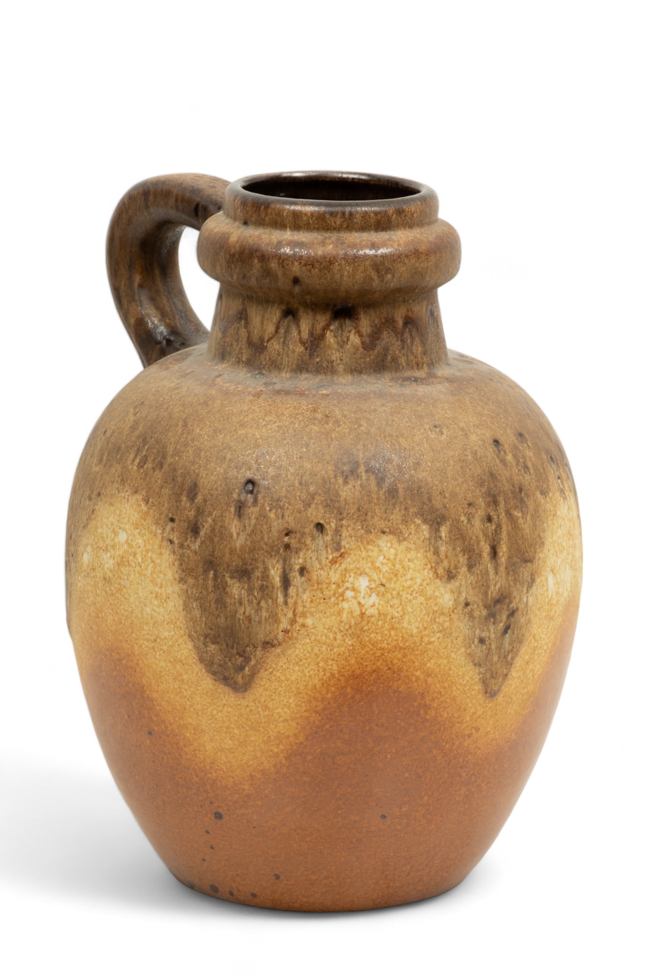 Scheurich Keramik (West German) Art Pottery Jug, H 15" W 11" L 12": Scheurich Keramik (West German) Art Pottery Jug, H 15" W 11" L 12" | Large drip mat and glazed finish. Having a substantial handle attaching to a ring just below upper rim. Tan to brown earthen tones.