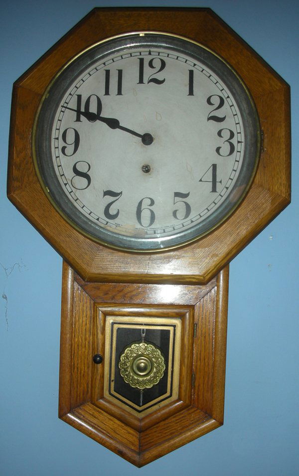 SESSIONS 'CLINTON' OAK WALL CLOCK: SESSIONS 'CLINTON' OAK WALL CLOCK, H 27", W 17":With key and pendulum. From the Estate of Robert and Elizabeth Mandy, Bingham Farms, Mi.
