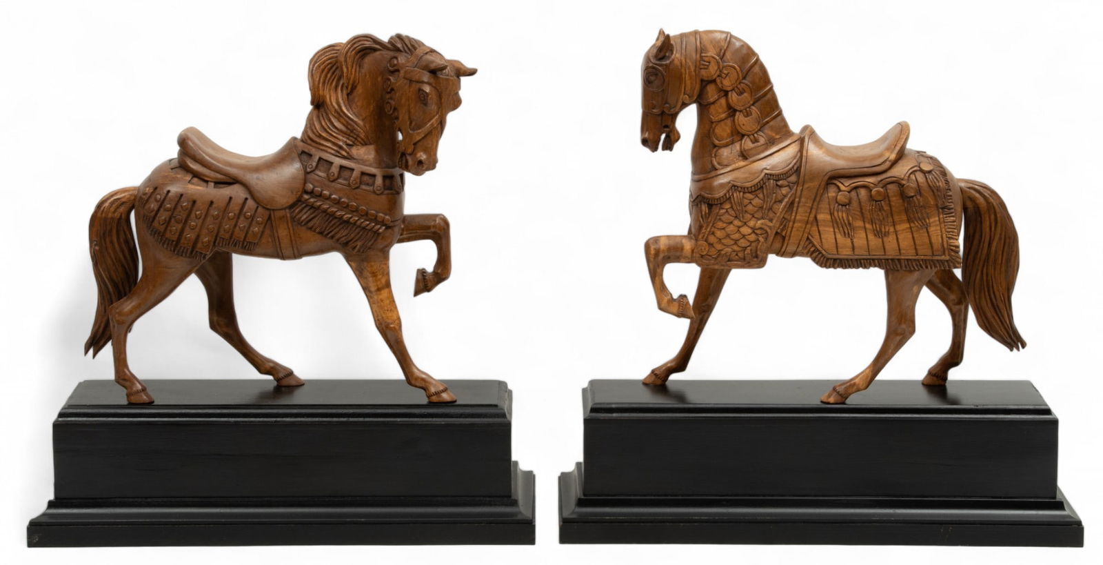 Miguel Martinez Ruelas (Mexican, 20th C.) Carved Wood Sculptures, Standing Horses H 18" W 5" L 18" 1: Miguel Martinez Ruelas (Mexican, 20th C.) Carved Wood Sculptures, Standing Horses H 18" W 5" L 18" 1 Pair | Both signed on the undersides. Two standing horses mounted to black painted wood plinth base