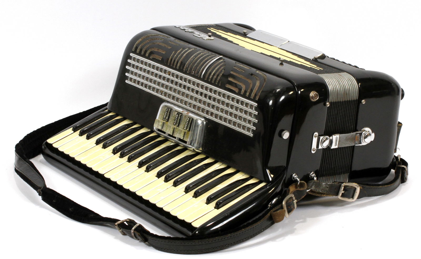 Italian "Venice" Bakelite Accordion, Ca. Mid 20th C., H 7.5'' W 15'' L 14'': Italian "Venice" Bakelite Accordion, Ca. Mid 20th C., H 7.5'' W 15'' L 14'' | Having a black bakelite body, three-button settings marked Bassoon, Master, and Claranet. Faux mother of pearl keys. Inclu