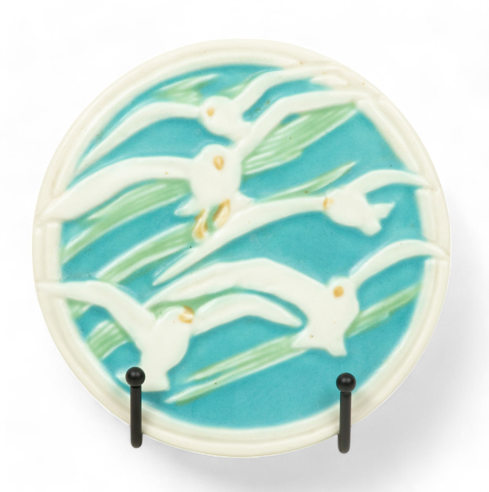 Rookwood Pottery (American) Seagull Decorated Ceramic Trivet, 1929, H 0.75" Dia. 5.75": Rookwood Pottery (American) Seagull Decorated Ceramic Trivet, 1929, H 0.75" Dia. 5.75" | the trivet offers a matte glaze decorating a bas relief of seagulls in flight. Produced in year XXIX (1929) wit
