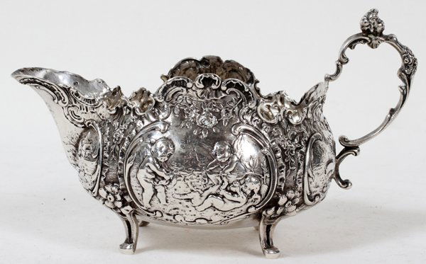 STORCK & SINSHEIMER SILVER CREAMER, HANAU,: STORCK & SINSHEIMER SILVER CREAMER, HANAU, 1874-1926, H 3 1/2", L 6":Elaborated decorated with putti, pastoral scenes, scroll, and flower motifs. Stamped with maker's mark, but no indication of the fi