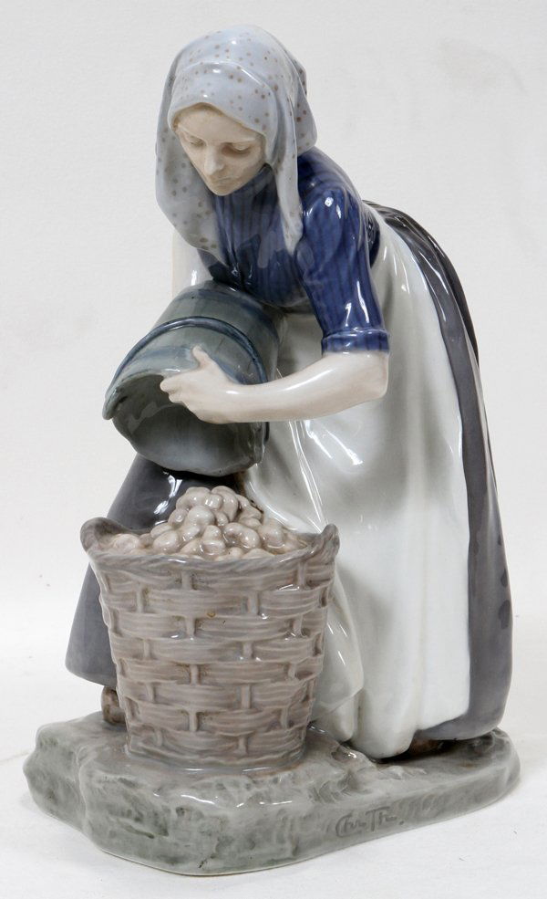 ROYAL COPENHAGEN PORCELAIN FIGURE OF A WOMAN: ROYAL COPENHAGEN PORCELAIN FIGURE OF A WOMAN, 1947, H 10 1/2":Figure of a woman dumping potatoes from a bucket into a basket, blue under glaze triple-wave mark, stamped trademark in green with mark in