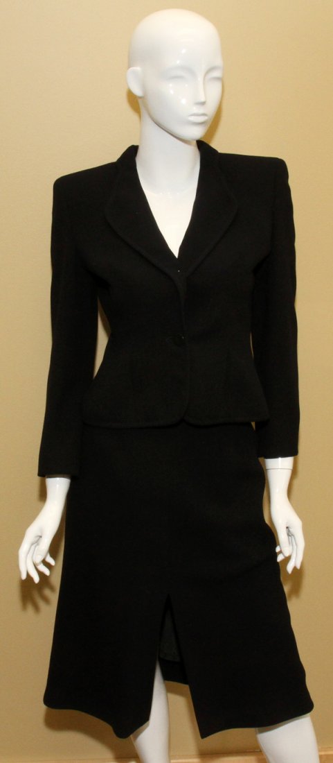 GIORGIO ARMANI WOOL SKIRT SUIT: GIORGIO ARMANI WOOL SKIRT SUIT:Navy blue wool, including 1 jacket with a single button close at the front, and 1 A-line skirt with slit at the front. Size 38. Labeled: Giorgio Armani. Two items total.