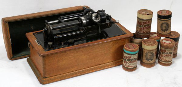 THOMAS EDISON CYLINDER PHONOGRAPH OAK CASE,: THOMAS EDISON CYLINDER PHONOGRAPH OAK CASE, OVER 25 CYLINDER RECORDS, H 12", W 9", L 18":Thomas EDISON CYLINDER PHONOGRAPH. With Over (25) Cylinder Records. Antique. - Size: 12" High x 18 1/2" Long x