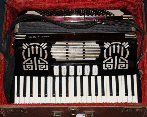 MAJOR ACCORDION CO. PIANO KEY ACCORDION: MAJOR ACCORDION CO. BLACK AND WHITE PIANO KEY ACCORDION:having six white keys which when individually pushed simulate a bassoon, clarinet, oboe, organ, violin and piccolo; With velvet lined case.