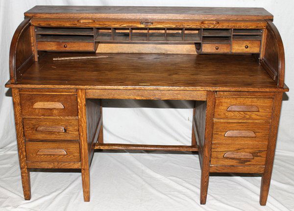 OAK ROLL TOP DESK, H 42", W 60", D 30": OAK ROLL TOP DESK, H 42", W 60", D 30":Opens to 12 pigeon holes, 3 drawers and large working surface, 3 drawers flank each side of kneehole, square tapered legs and cross support in kneehole.