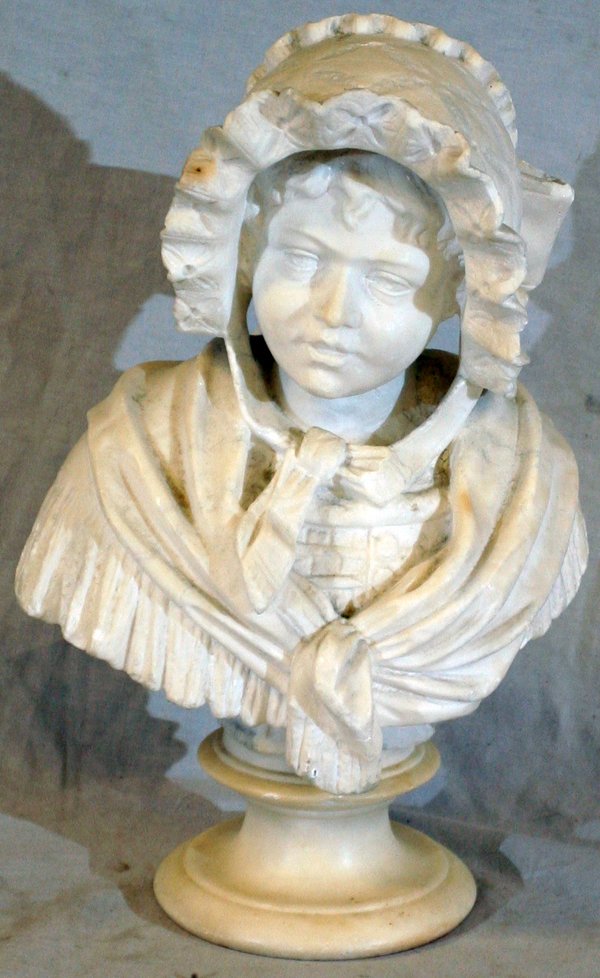 CARVED MARBLE BUST, H 13", W 8": CARVED MARBLE BUST, H 13", W 8":depicting a young girl wearing a bonnet; On alabaster plinth.