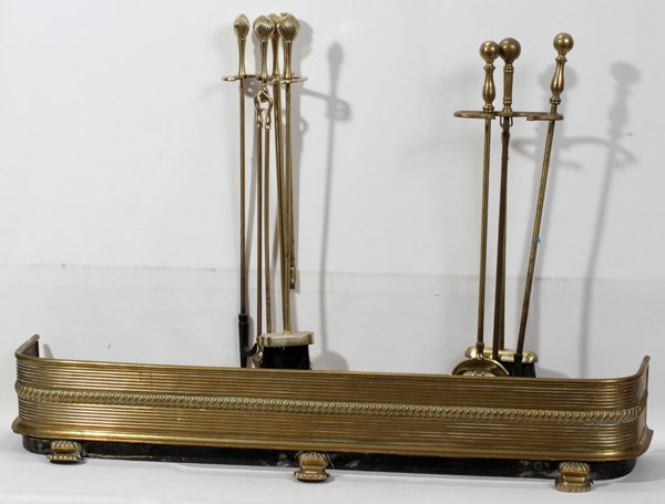BRASS FENDER & FIRE TOOLS, 2 SETS, H 8", L 45": BRASS FENDER & FIRE TOOLS, 2 SETS, H 8", L 45":Good quality English brass fender L 45" H 8" Footed. Brass firetools with shell finials include holder, tongs, brush and poker. Second set of tools inclu