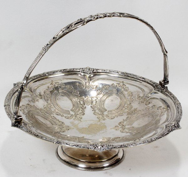 VICTORIAN ELECTROPLATE BASKET, WILLIAM HARRISON: VICTORIAN ELECTROPLATE SILVER BASKET BY WILLIAM WHEATCROFT HARRISON, 19TH C., H 10", DIA 11 1/2":An electroplate silver round basket with swing handle, engraved monogram at the well; stamped at the un