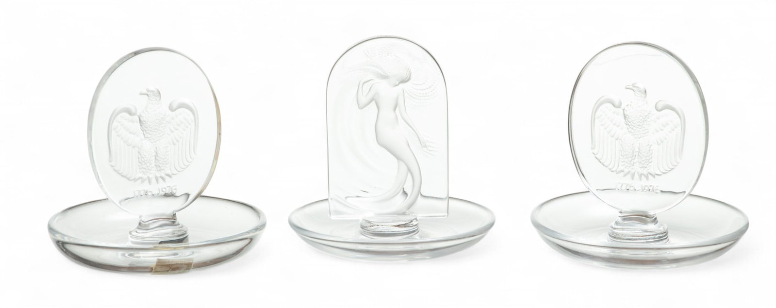 Lalique (French) Frosted Crystal 'Naiade' And 'Aigle' Round Pin Trays: Lalique (French) Frosted Crystal 'Naiade' And 'Aigle' Round Pin Trays The lot comprises of one 'Naiade' pin tray and two 'Aigle' pin trays. Each bearing signature branding incised to the undersides. D