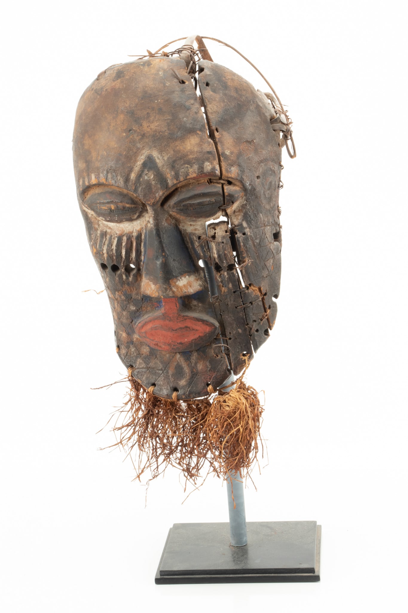 African Polychrome Carved Wood, Metal, And Fiber Mask H 11.5'' W 7'': African Polychrome Carved Wood, Metal, And Fiber Mask H 11.5'' W 7'' On modern composite base. Dimensions: 1 x H 11.50'' W 7''