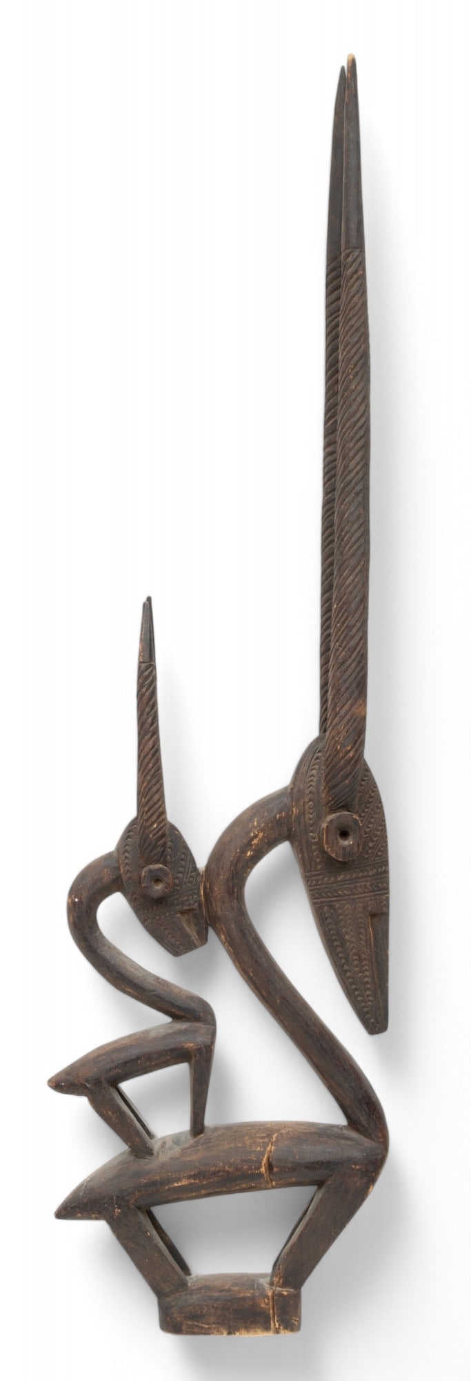 Mali, Bamana Peoples, Wood Female Antelope Headdress (Ci Wara), Ca. Early 20th C. H 34" W 2.5" L 9.5: Mali, Bamana Peoples, Wood Female Antelope Headdress (Ci Wara), Ca. Early 20th C. H 34" W 2.5" L 9.5" Female antelope with an infant (female) antelope on its back, with curving necks and vertically ca