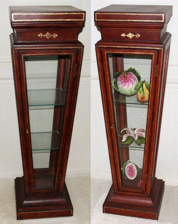 MAITLAND-SMITH LEATHER-CLAD CURIO PEDESTALS, 2: MAITLAND-SMITH LEATHER-CLAD CURIO PEDESTALS, TWO, H 48", W 14", D 14":having a square top with tooled leather gilt inlay, tapered pedestal with framed glass sides, a single door inset with glass. Squa