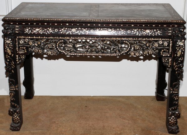 CHINESE TEAKWOOD ALTAR TABLE W/INLAY, 19TH C.: CHINESE TEAKWOOD ALTAR TABLE WITH MOTHER-OF-PEARL INLAY, 19TH C., H 38", W 52", D 22":Ornately carved with pierced apron and mother of pearl inlay and an inset marble top.