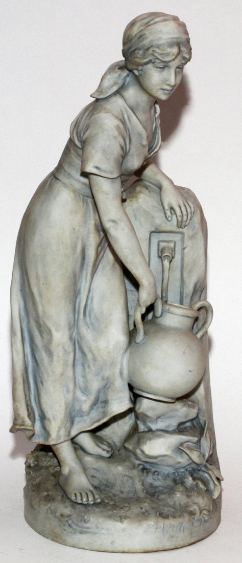 ROYAL DUX BISQUE YOUNG WOMAN AT WELL C. 1918-45: ROYAL DUX BISQUE YOUNG WOMAN AT WELL, C. 1918-45, H 23 1/2", W 10":Figure of a young woman drawing water from a well; signed at the side, pink triangular mark at the underside.