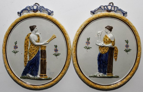 FRENCH FAIENCE OVAL PLAQUES, 19TH C., PAIR,: FRENCH FAIENCE OVAL PLAQUES, 19TH C., PAIR, 7 1/2" X 6":Each decorated with Classical style figures in bas relief. From the Dean and Mary Rockwell Collection.