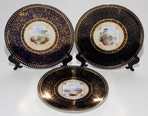 ENGLISH PORCELAIN SCENIC PLATES, 19TH C., THREE,: ENGLISH PORCELAIN SCENIC PLATES, 19TH C., THREE, DIA 9":Each has a unique transfer-decorated landscape at the well, cobalt blue ground with gilt accents. No markings, probably Spode.