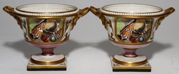 SPODE, ENGLISH PORCELAIN URNS, 19TH C., PAIR, H 4": SPODE, ENGLISH PORCELAIN URNS, 19TH C., PAIR, H 4", DIA 5 1/2":Each is flanked by ram's mask handles and is decorated with reserves enclosing shells, raised on a pedestal base. No markings, probably S