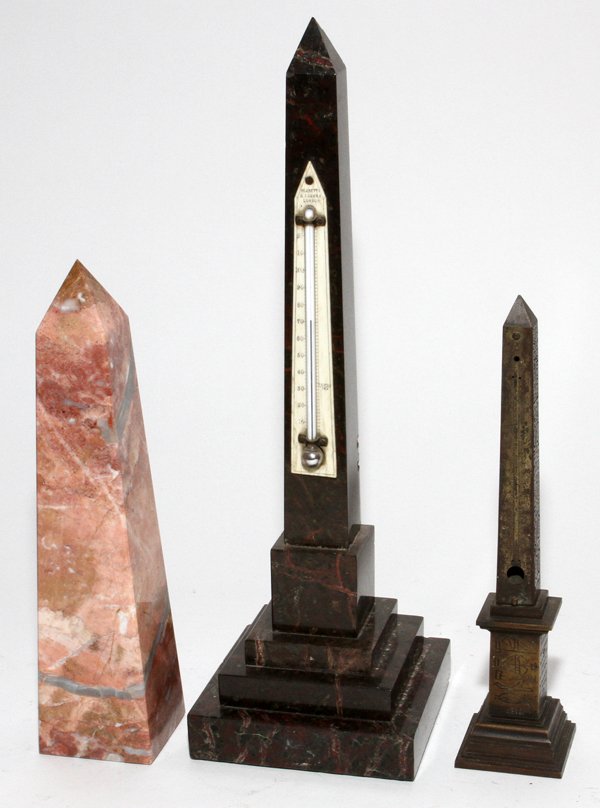 MARBLE & BRASS OBELISKS, THREE, H 9 1/2"-14 1/2": MARBLE & BRASS OBELISKS, THREE, H 9 1/2"-14 1/2":Including 1 small Egyptian style obelisk (lacking thermometer), 1 pink marble obelisk, and 1 dark marble obelisk with a thermometer with an ivory backi
