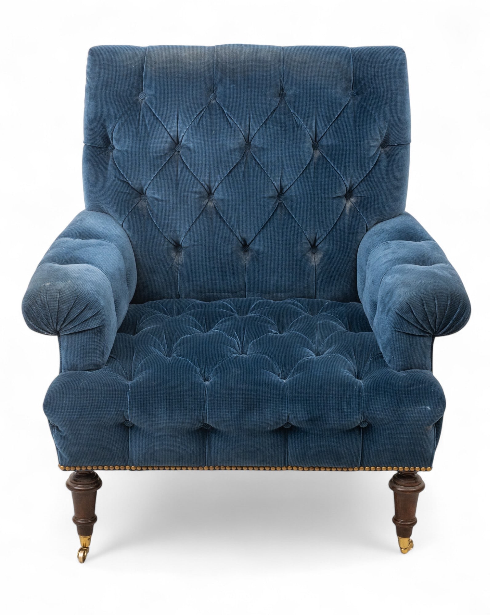 Blue Corduroy Upholstered Gentleman's Lounge Arm Chair 20th C. H 39" W 34" Depth 32": Blue Corduroy Upholstered Gentleman's Lounge Arm Chair 20th C. H 39" W 34" Depth 32" Rolled arms with tufted back and seat. On turned mahogany legs with brass nail head trim Provenance: From the