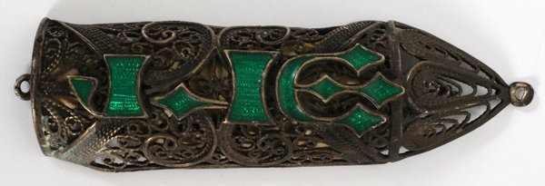 HEBREW SILVER ENAMEL MEZUZAH WITH MINI SCROLL: HEBREW SILVER AND ENAMEL MEZUZAH WITH MINIATURE SCROLL, C1900, L 3":having a silver filigree design with enamel Hebrew script (God) on the front. Miniature scroll rolled inside of piece.