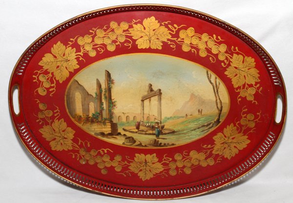 ENGLISH TOLE GALLERY TRAY, L 21": ENGLISH TOLE GALLERY TRAY, L 21":Oval tray with pierced gallery and handles, red ground centered by an oval reserve enclosing Classical ruins with figures. Measures L.21" x 15 1/2".